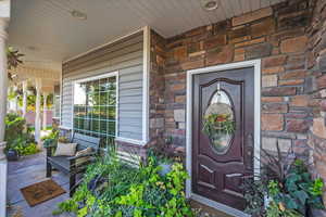 Property entrance featuring stone siding