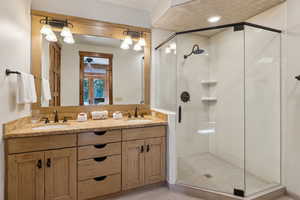 Full bath with a stall shower and double vanity
