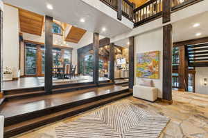 Building lobby featuring high vaulted ceiling, wooden ceiling, and recessed lighting