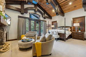 Bedroom with a wood ceiling with exposed beams, french doors, carpet flooring, and high vaulted ceiling