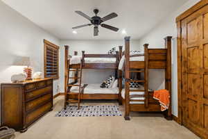 Bedroom featuring light carpet, ceiling fan, and recessed lighting