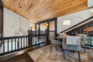 Dining space with wooden ceiling, dark wood finished floors, and a chandelier