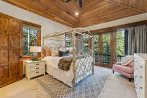 Bedroom featuring wood ceiling, carpet floors, vaulted ceiling, access to exterior, and a ceiling fan