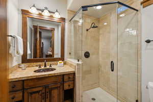Full bathroom with a stall shower and vanity