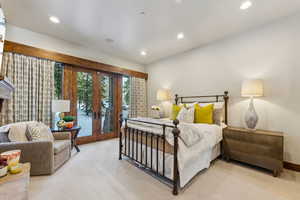 Carpeted bedroom with french doors, access to outside, and recessed lighting