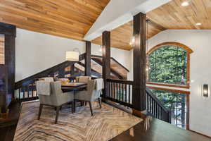 Dining space featuring wood finished floors, vaulted ceiling, and wooden ceiling