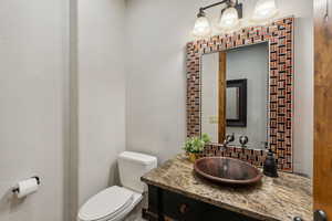 Bathroom with tasteful backsplash and vanity