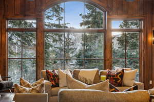 Living room featuring view of wooded area