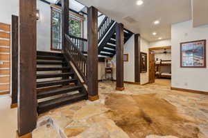Stairway featuring stone floors, recessed lighting, and a ceiling fan