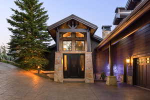 View of exterior entry featuring stone siding