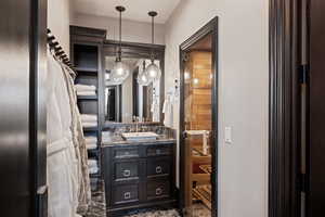 Half bathroom with vanity and a sauna