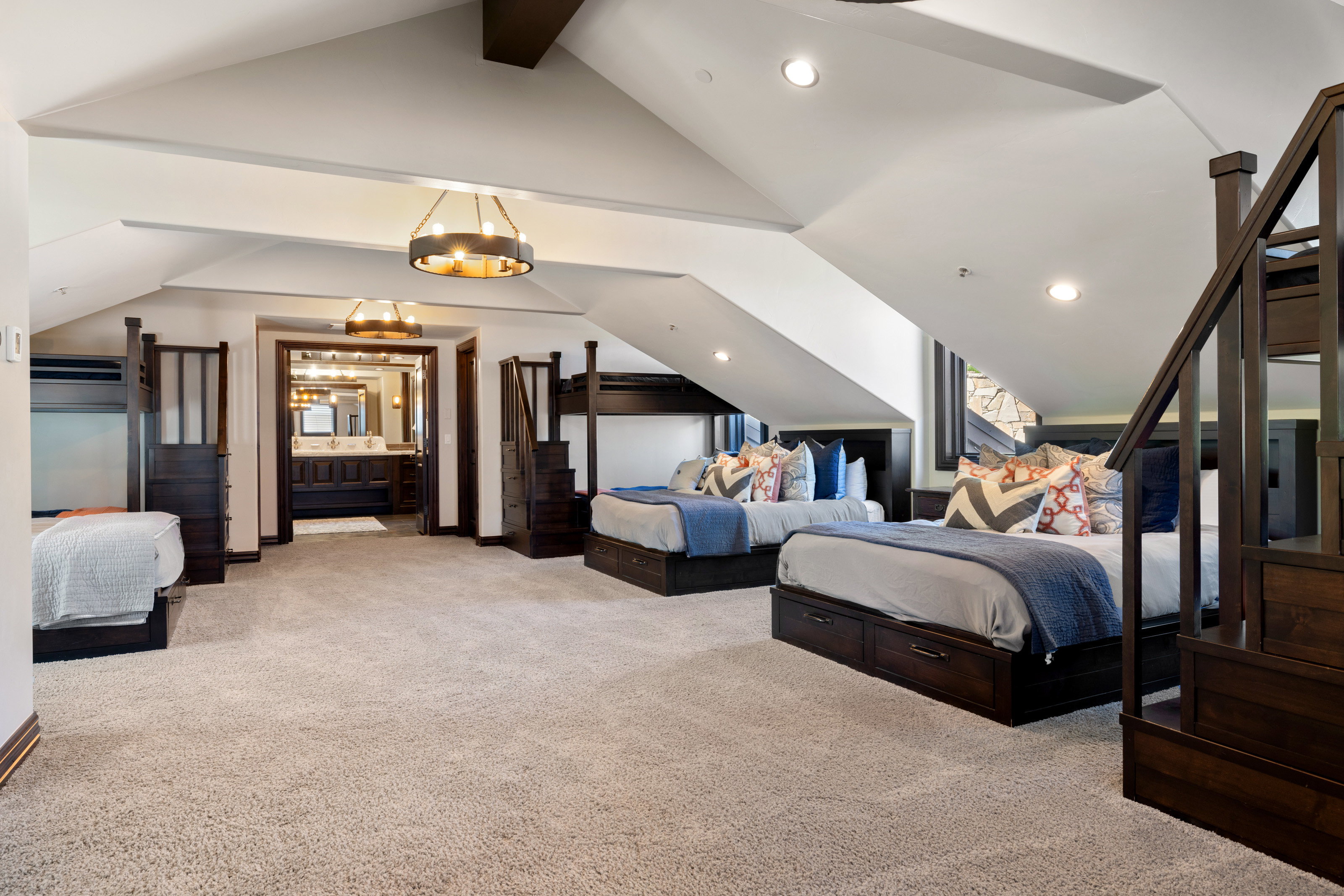 Bedroom featuring light carpet, ensuite bath, and recessed lighting
