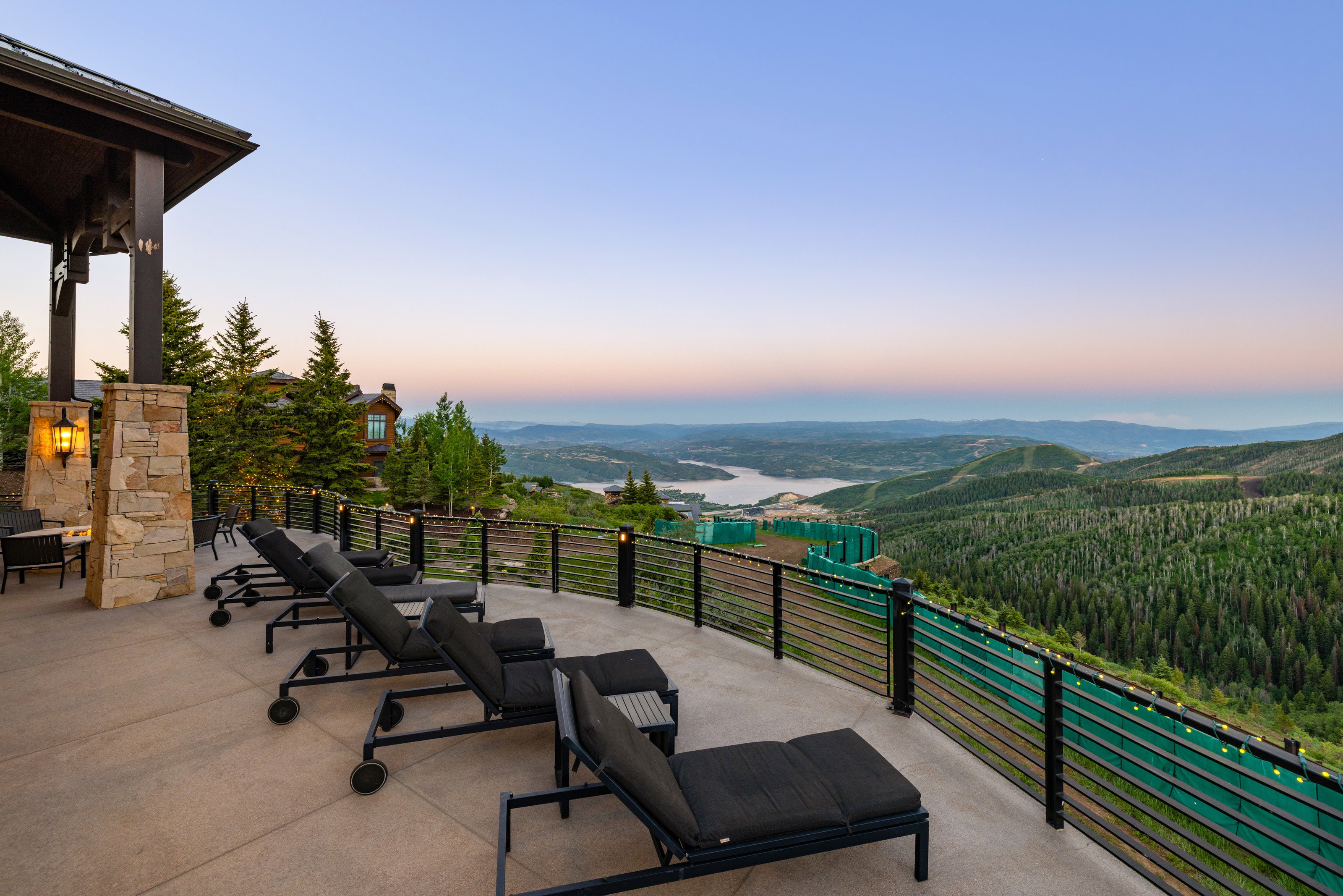 Patio terrace at dusk with a patio area and a wooded view