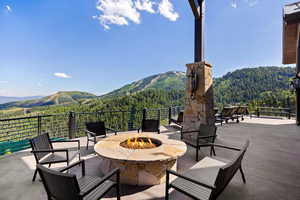 View of patio featuring a forest view, a mountain view, and an outdoor fire pit