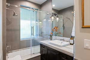 Bathroom featuring tiled shower / bath combo and vanity