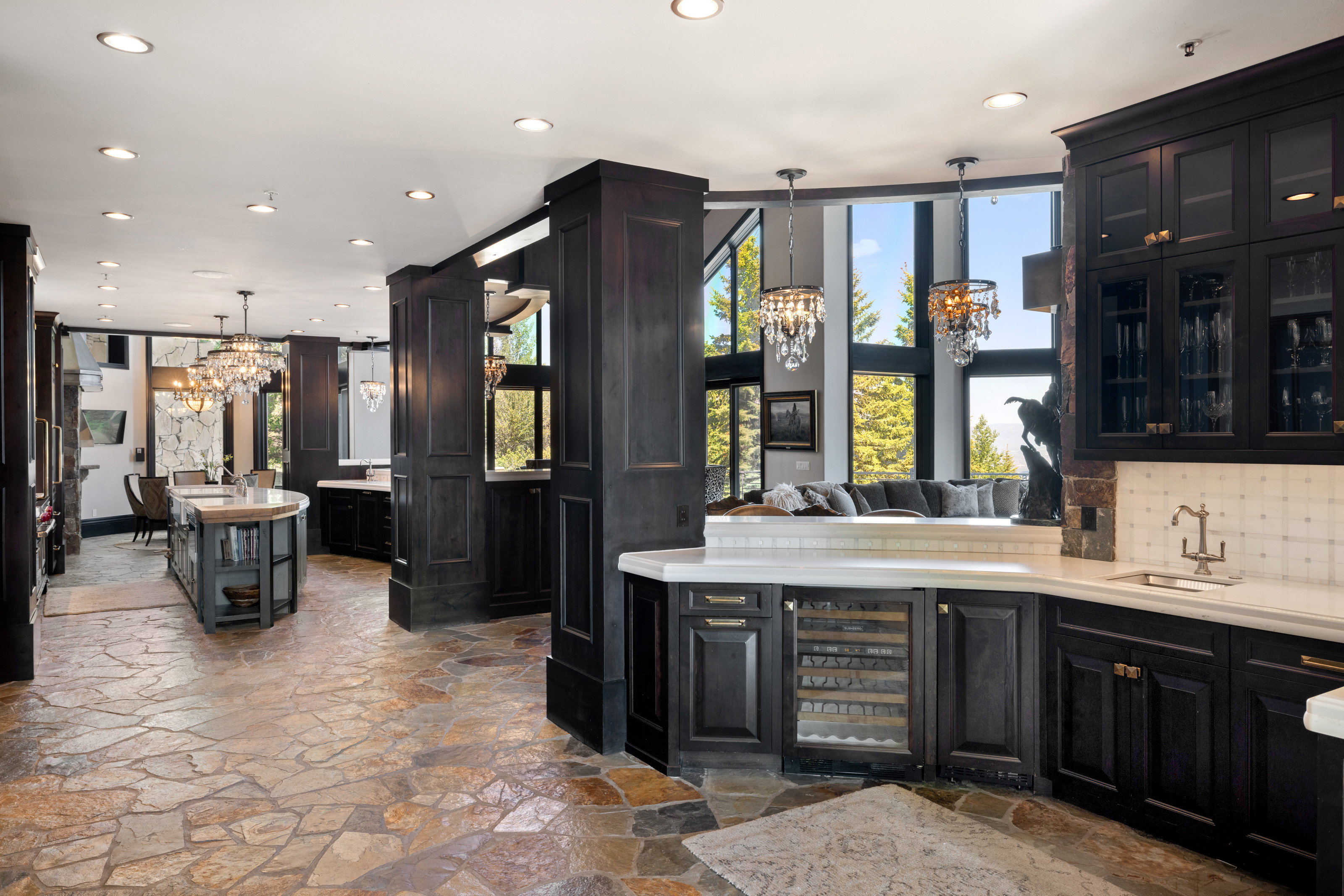 Bar with a chandelier, recessed lighting, beverage cooler, dark cabinets, and decorative light fixtures
