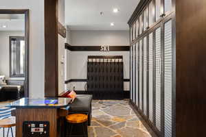 Interior space with stone flooring and recessed lighting