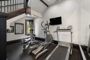 Workout room with lofted ceiling and recessed lighting