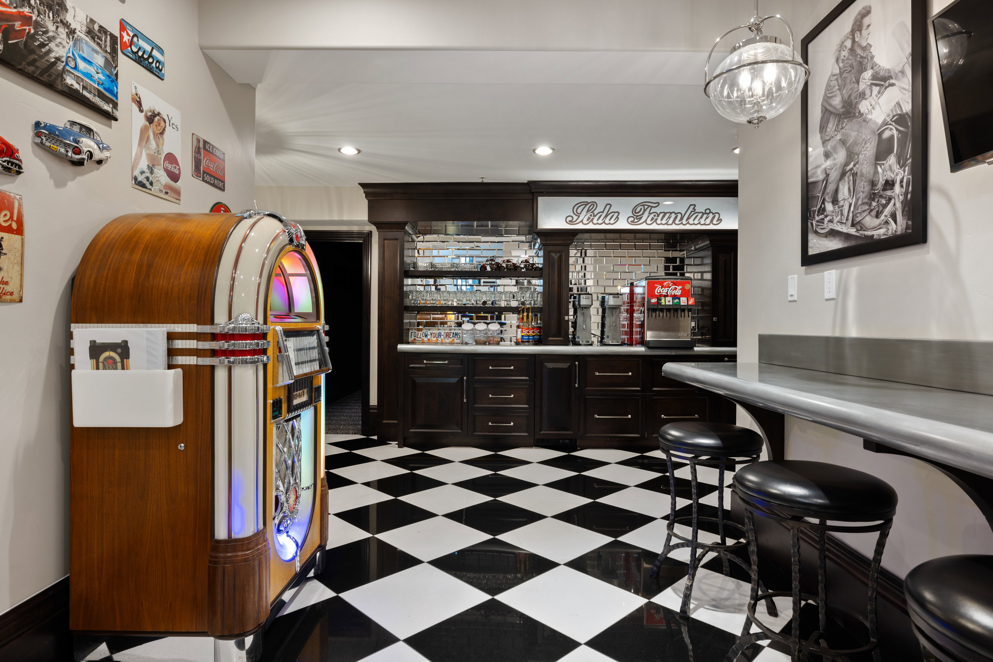 Community bar area with recessed lighting, light countertops, and dark brown cabinetry