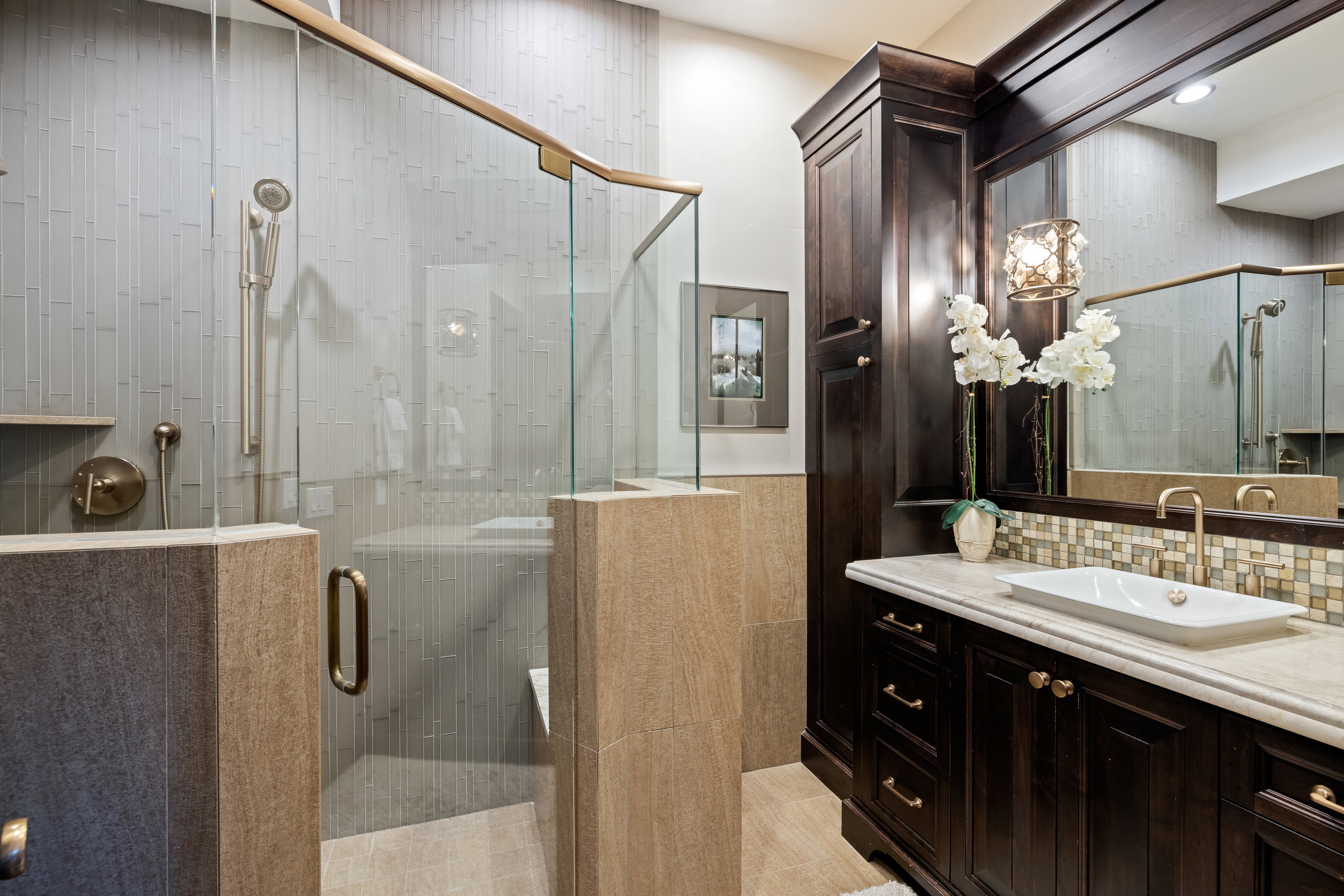 Bathroom featuring vanity, a stall shower, and decorative backsplash