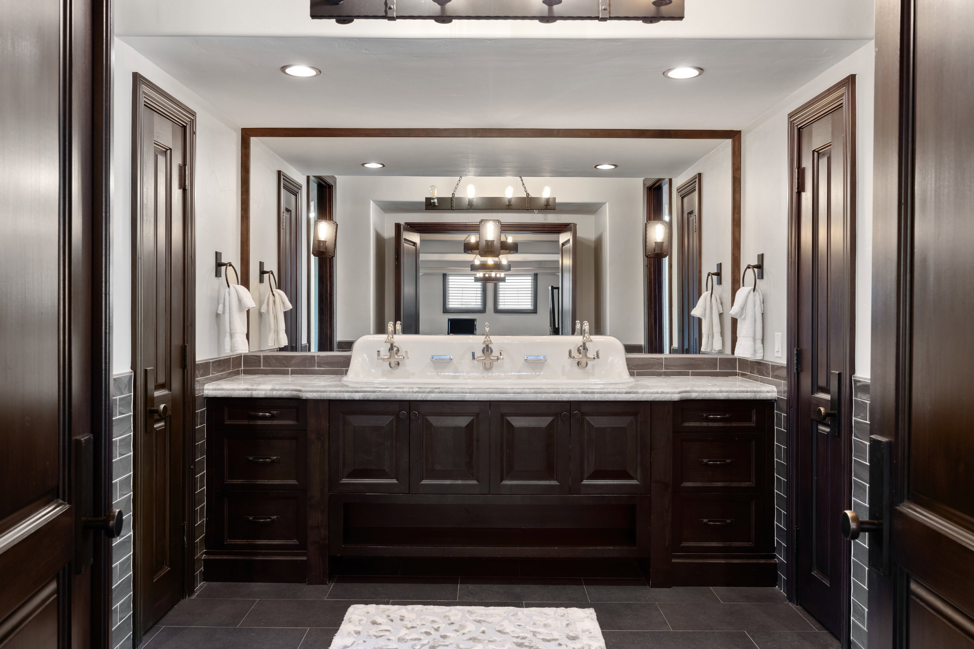 Bathroom featuring vanity, recessed lighting, and dark tile patterned flooring