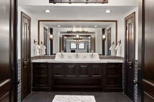 Bathroom featuring vanity, recessed lighting, and dark tile patterned flooring