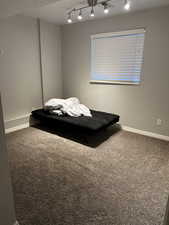 Carpeted bedroom with baseboards