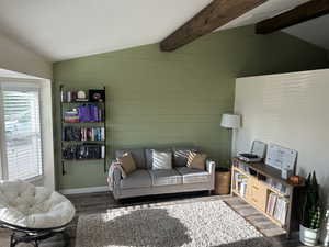 Living room featuring wood walls and wood finished floors