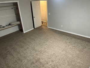 Unfurnished bedroom featuring carpet floors and a closet