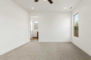 Empty room featuring light colored carpet, recessed lighting, and a ceiling fan