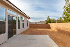 Fenced backyard featuring a patio area and a mountain view