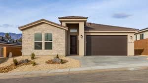 View of front of property featuring stone siding, stucco siding, concrete driveway, an attached garage, and a tiled roof
