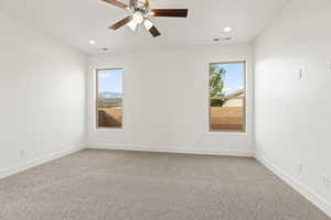 Empty room featuring light colored carpet, recessed lighting, and a ceiling fan