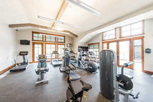 Exercise room featuring recessed lighting, french doors, and high vaulted ceiling