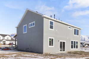 Snow covered property with a mountain view