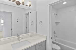 Bathroom featuring vanity,  shower combination, and a chandelier