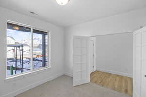 Spare room featuring light carpet and baseboards