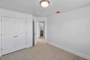 Unfurnished bedroom with carpet floors and a closet