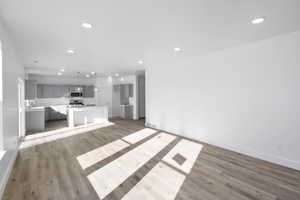 Unfurnished living room with recessed lighting and light wood-style floors