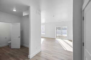 Hall featuring light wood-style flooring and recessed lighting