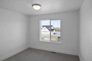 Empty room with carpet flooring and baseboards