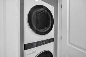 Laundry room featuring stacked washer / dryer