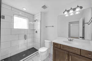 Full bath featuring a stall shower, vanity, light marble finish flooring, and recessed lighting