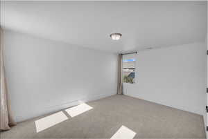 Unfurnished room with carpet floors and baseboards