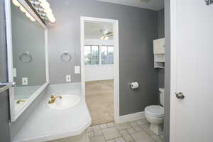 Half bathroom with vanity and a ceiling fan
