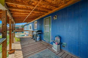 Wooden terrace featuring a grill