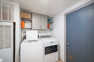 Laundry area with a heating unit, washing machine and clothes dryer, and cabinet space