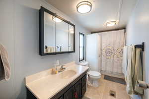Bathroom featuring vanity, light tile patterned flooring, and shower / bathtub combination with curtain