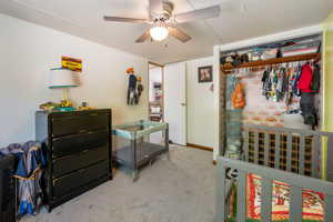 Bedroom featuring light carpet and a ceiling fan