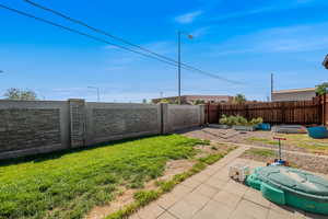 Fenced backyard with a patio area